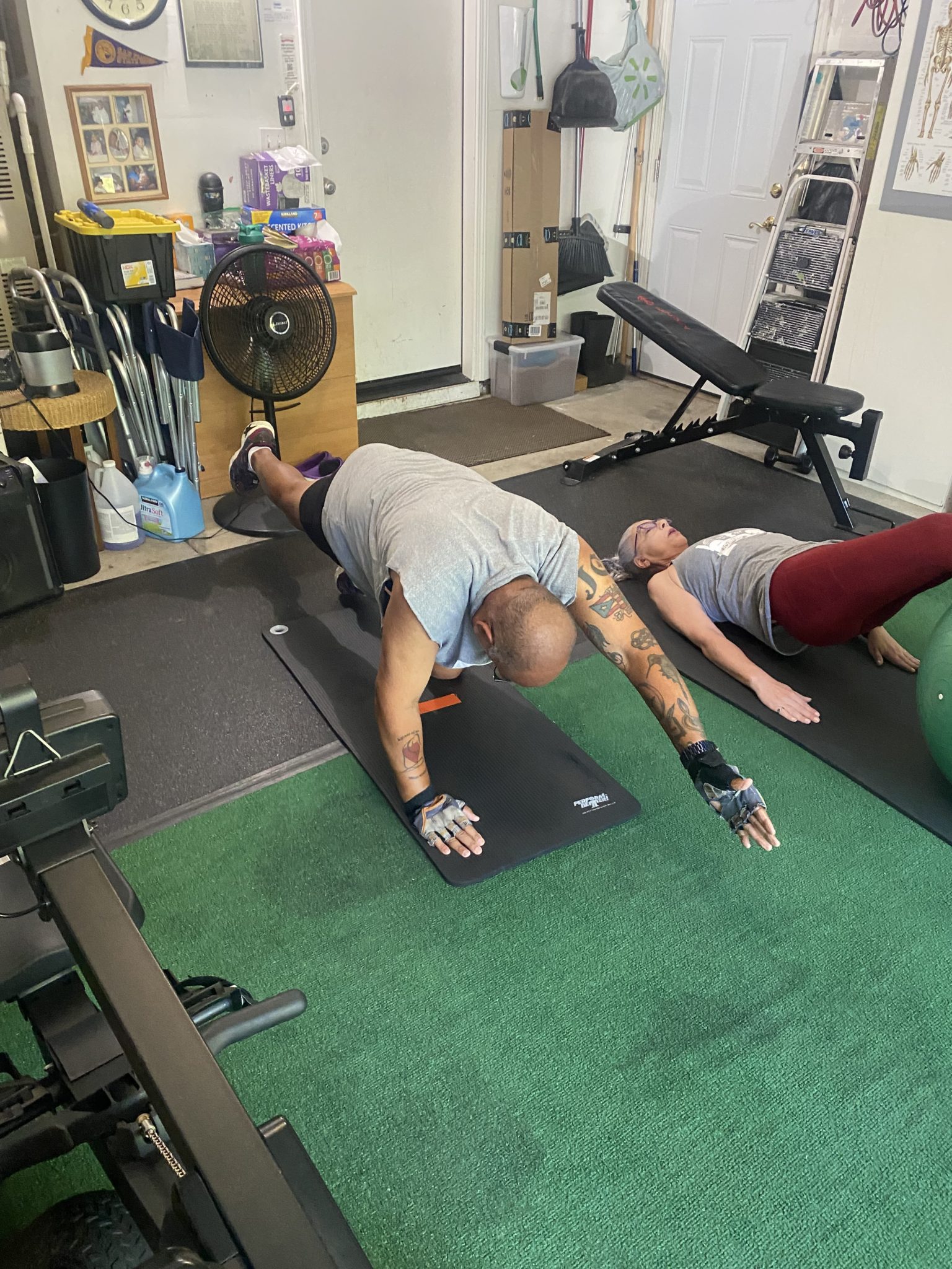 Two clients holding a push-up position during a session