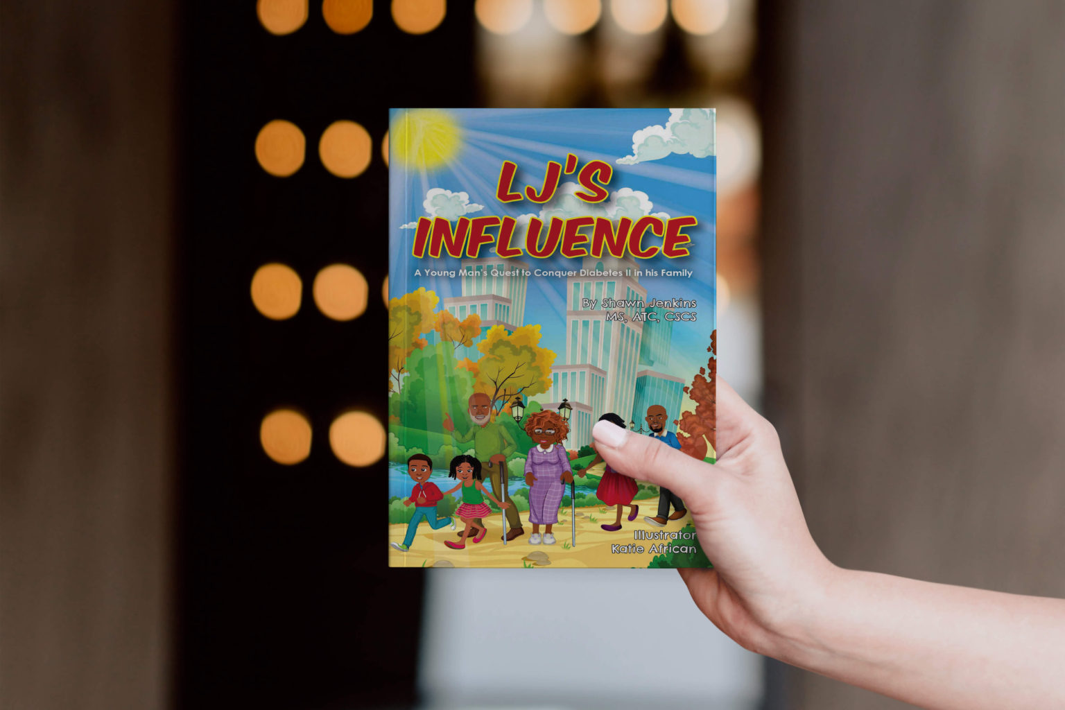 A hand holding a paperback copy of LJ's Influence