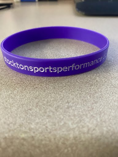A purple Stockton Sports Performance wristband